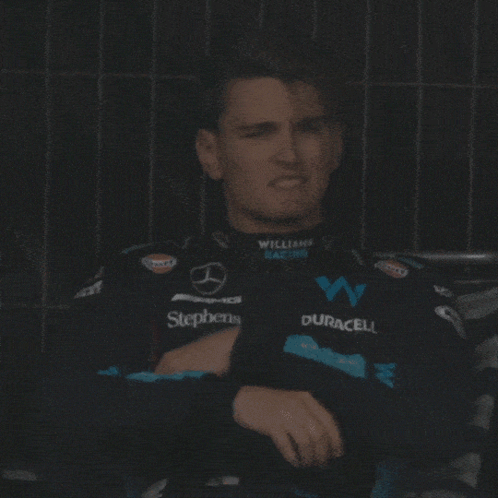 Man Sitting in Williams Racing Jacket