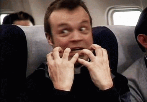 Man Sitting on Airplane Making Funny Face