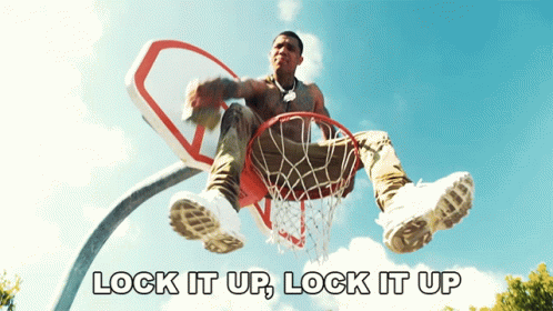 Man Sitting on Basketball Hoop Saying Lock It Up