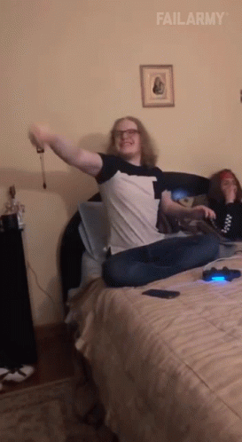 Man Sitting On Bed Arms Outstretched Failarmy GIF