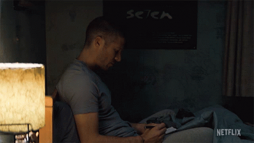Man Sitting On Bed In Front Of Setek Poster GIF
