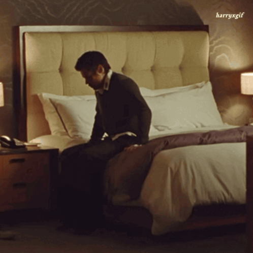 Man Sitting on Bed With harryxgif Watermark