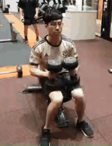 Man Sitting On Bench Holding Dumbbell GIF