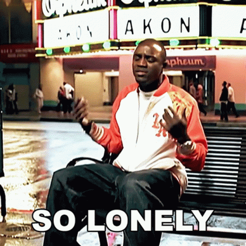 Man Sitting On Bench In Front Of Akon Sign GIF
