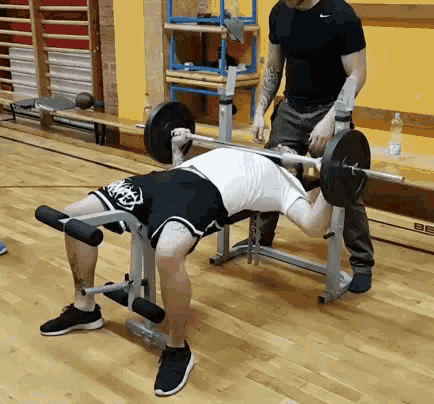 Man Sitting on Bench Lifting Barbell