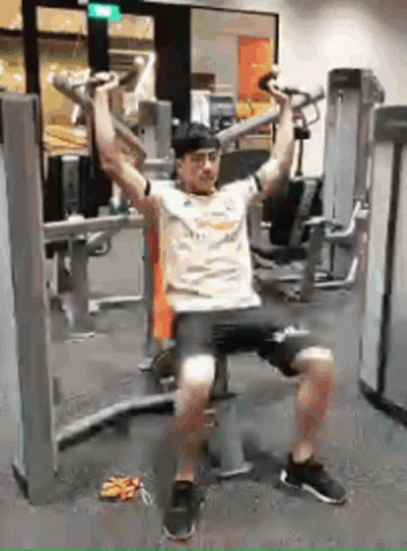 Man Sitting On Bench Using Gym Machine GIF