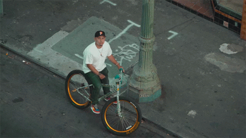 Man Sitting on Bicycle with Number 7