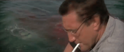 Man Sitting on Boat Looking at Bell