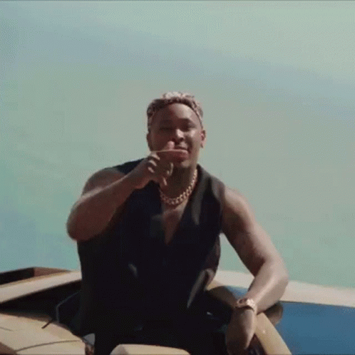 Man Sitting on Boat with Hand on Face