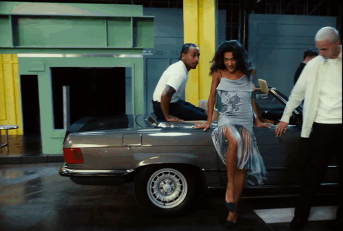 Man Sitting On Car Back Woman Leaning GIF
