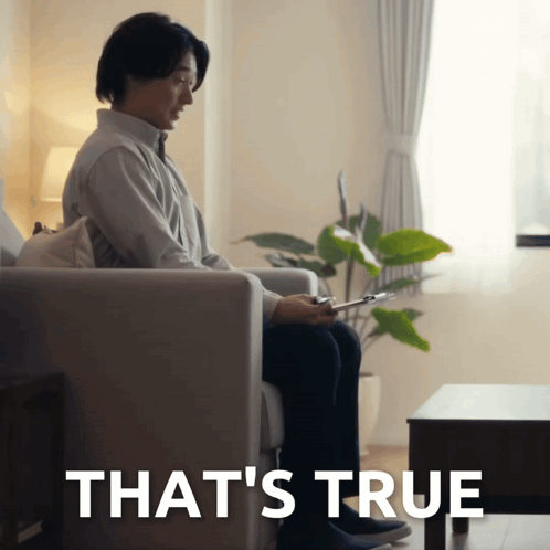 Man Sitting on Couch Behind True