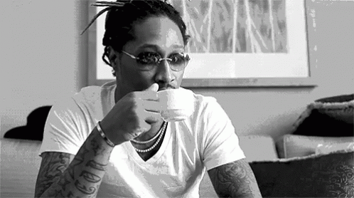 Man Sitting on Couch Drinking Coffee
