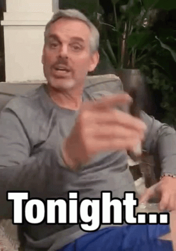 Man Sitting on Couch Holding Glass Saying Tonight