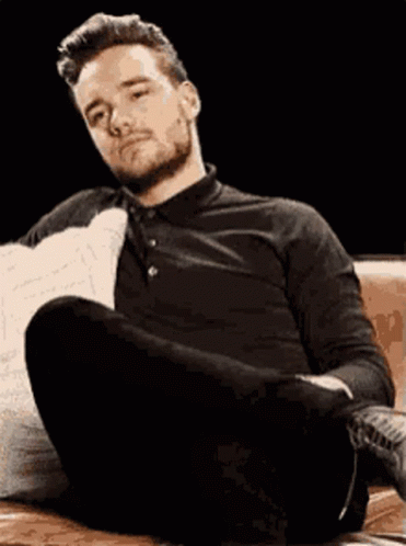 Man Sitting on Couch Legs Crossed Head Down