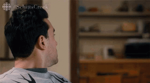 Man Sitting On Couch Looking Away GIF