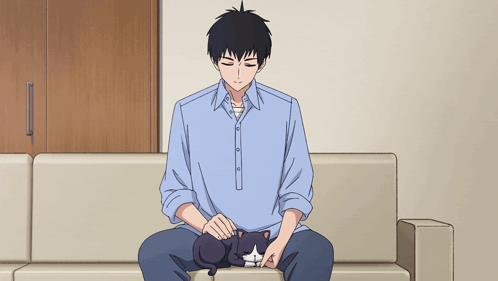 Man Sitting on Couch Petting Black Cat