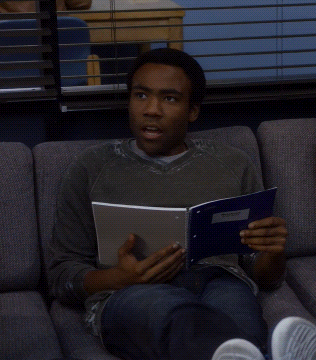 Man Sitting on Couch Reading Book Am I Using That Right