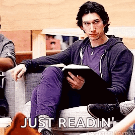 Man Sitting On Couch Reading Book GIF