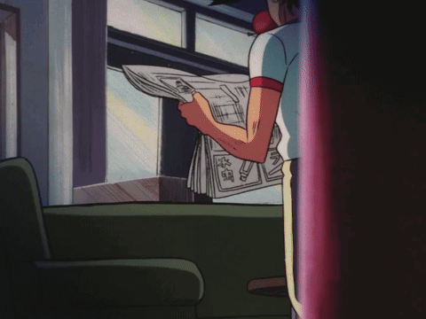 Man Sitting on Couch Reading Goro Newspaper