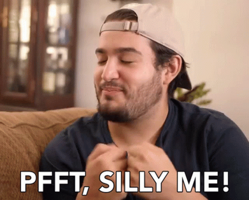 Man Sitting on Couch Saying Pfft Silly Me