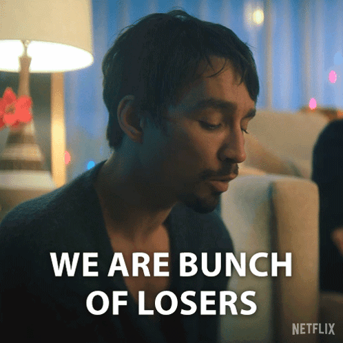 Man Sitting on Couch Saying We Are Losers