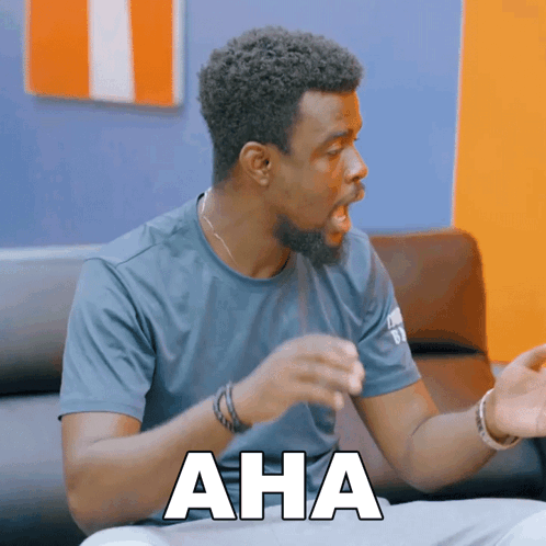 Man Sitting on Couch With Aha on Chest
