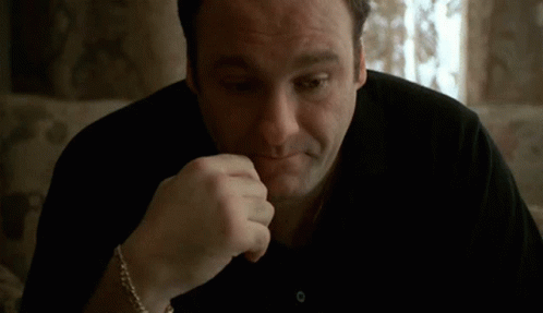 Man Sitting On Couch With Hand On Chin GIF