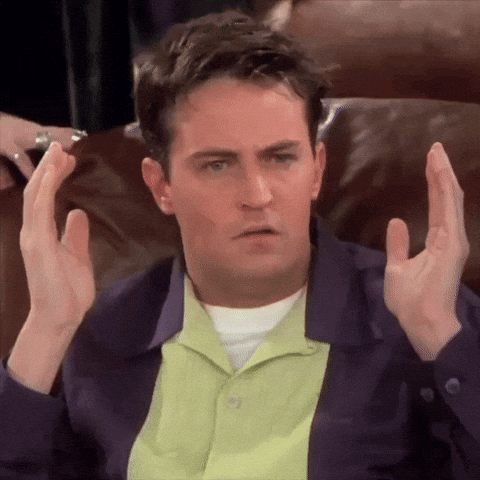 Man Sitting on Couch With Hands Up