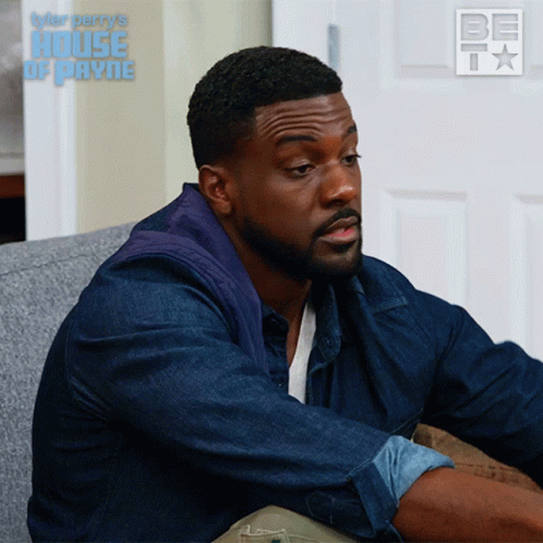 Man Sitting on Couch With House of Payne Logo