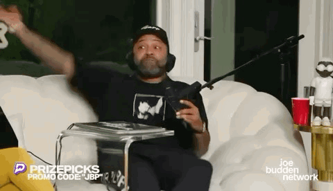 Man Sitting on Couch with Microphone