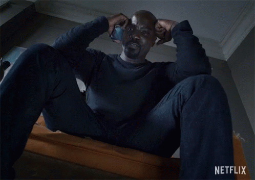 Man Sitting On Couch With Netflix Logo GIF
