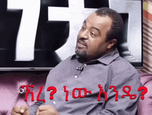 Man Sitting On Couch With Red Question Mark GIF