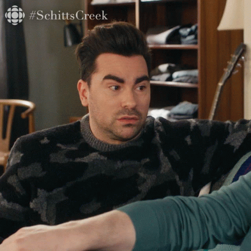 Man Sitting On Couch With #Schitts Creek GIF