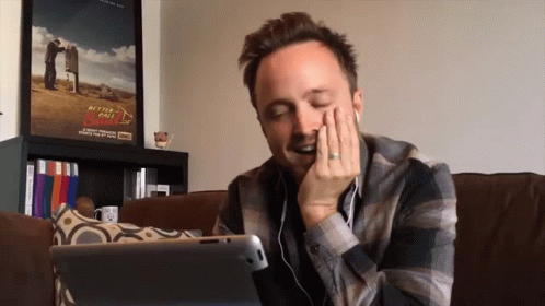 Man Sitting On Couch With Tablet And Better Call Saul Poster GIF