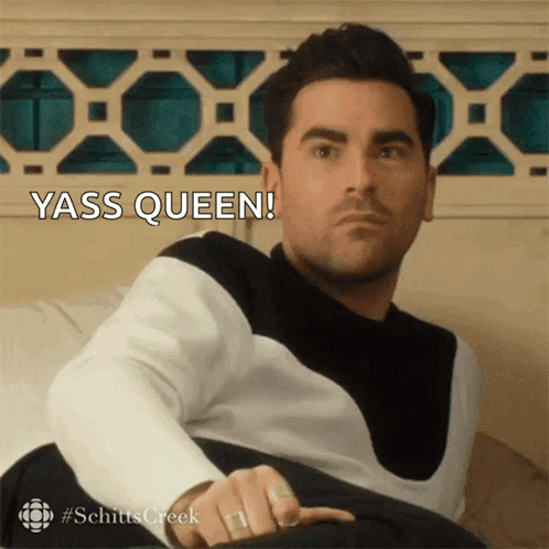 Man Sitting on Couch With Yass Queen Behind Him
