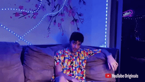 Man Sitting on Couch with YouTube Originals Logo