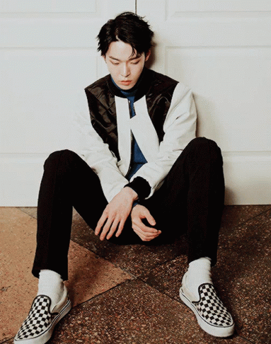Man Sitting on Floor in Black and White Checkered Shoe