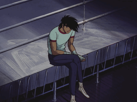 Man Sitting on Ledge with Head Down