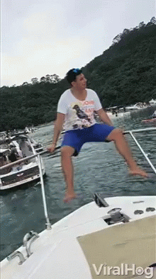 Man Sitting On Side Of Boat In Water GIF