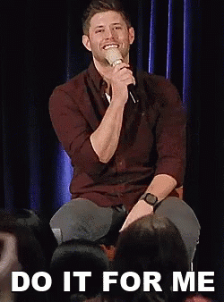 Man Sitting On Stage Holding Microphone GIF