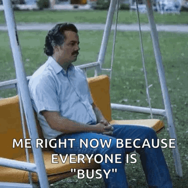 Man Sitting on Swing in Park