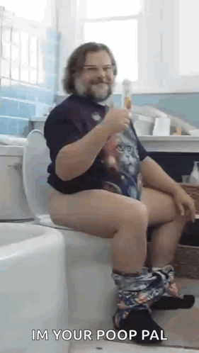 Man Sitting on Toilet Holding Beer