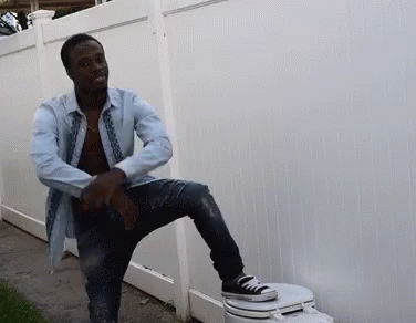 Man Sitting on Toilet With Leg Up