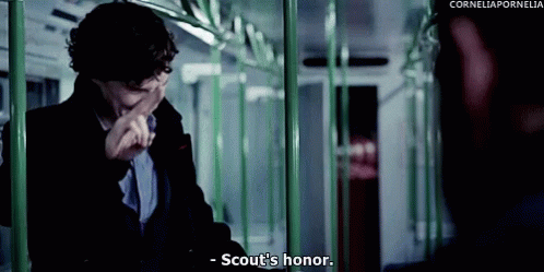 Man Sitting on Train Covering Mouth Saying Scout's Honor