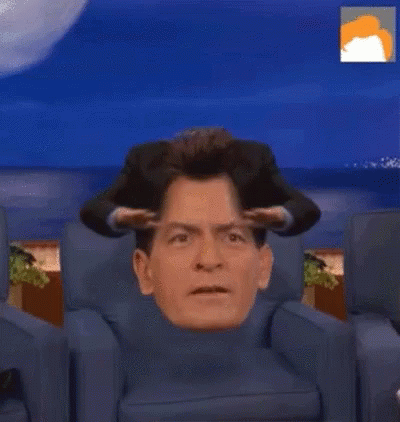 Man Sitting With Head In Turtleneck GIF