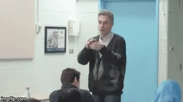 Man Sitting With Serious Expression GIF