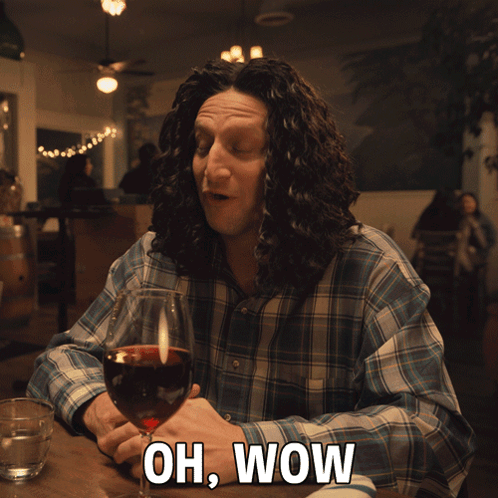 Man Sitting With Wine Saying Oh Wow
