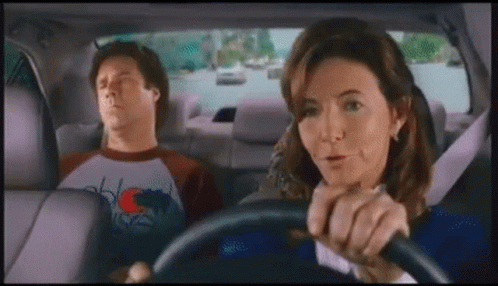 Man Sleeping in Back Seat While Woman Drives