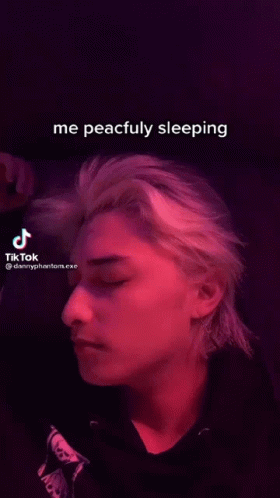Man Sleeping in Dark Room with TikTok Video