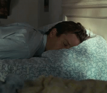 Man Sleeping on Bed with Blue Comforter